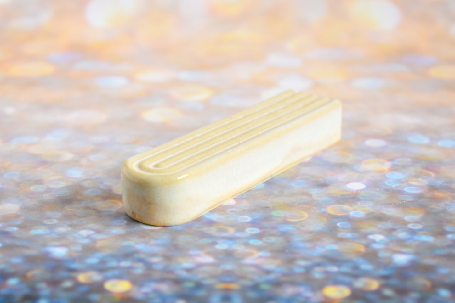 Handmade ceramic mezuzah titled 'Arch Mezuzah - Cream' – modern Judaica by Feldi Studios