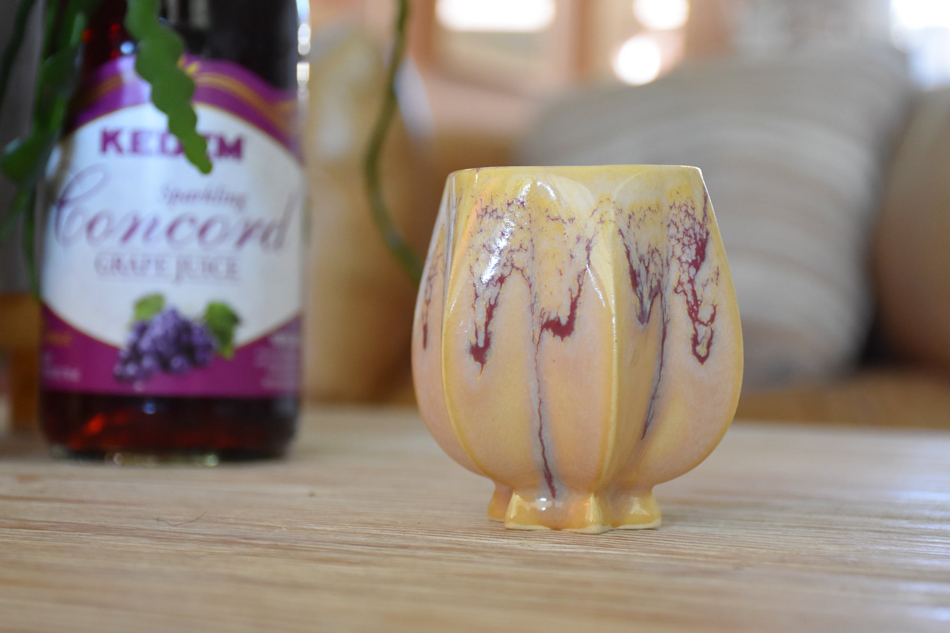 Handmade ceramic kiddush cup titled 'Pom Kiddush Cup - Gold Purple and Blue Drip' – modern Judaica by Feldi Studios