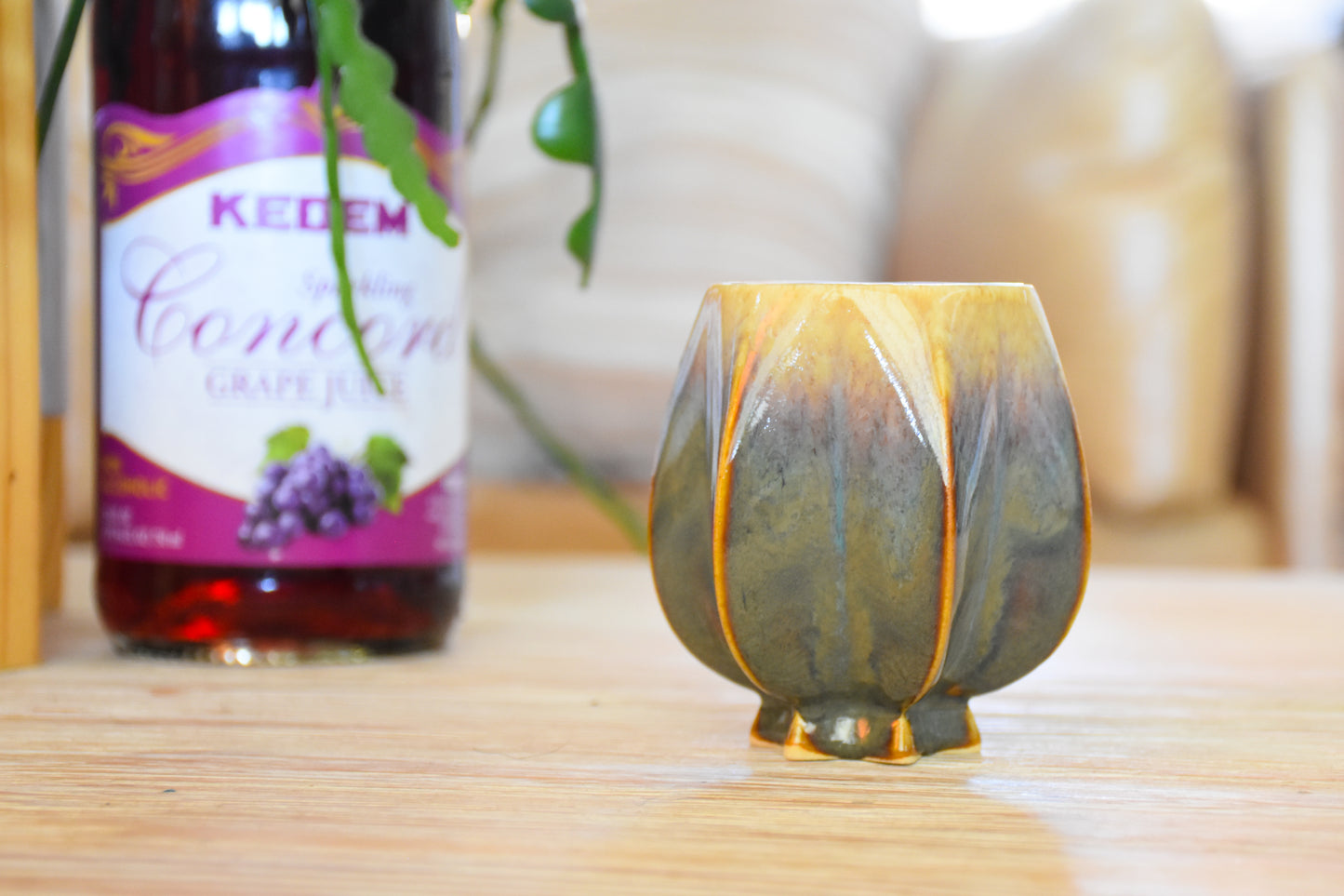 Handmade ceramic kiddush cup titled 'Pom Kiddush Cup - Green + Gold' – modern Judaica by Feldi Studios