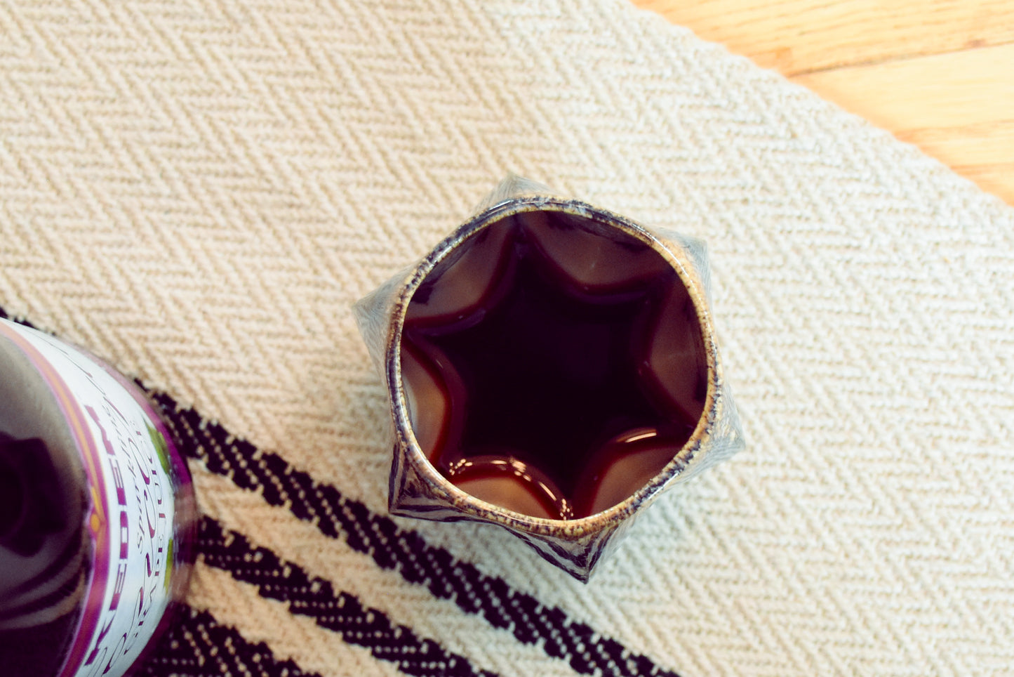 Top view of stemmed kiddush cup showing jewish star shape formed by wine.