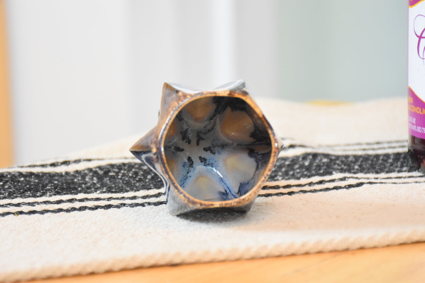 Interior details of stemmed shabbat kiddush cup showing or glaze dripping.