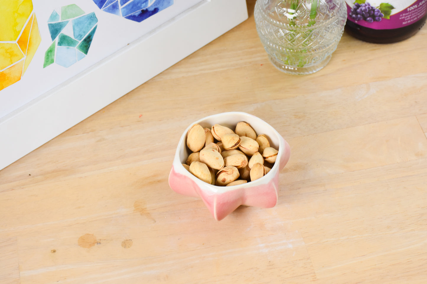 Pom honey pot filled with nuts showing versatility of product