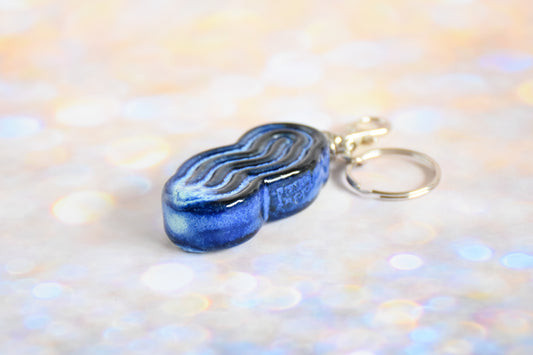 Handmade ceramic accessory titled 'Squigglet Fidget Charm Keychain - Blue' – modern Judaica by Feldi Studios