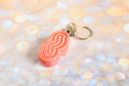 Handmade ceramic accessory titled 'Squigglet Fidget Charm Keychain - Pink' – modern Judaica by Feldi Studios