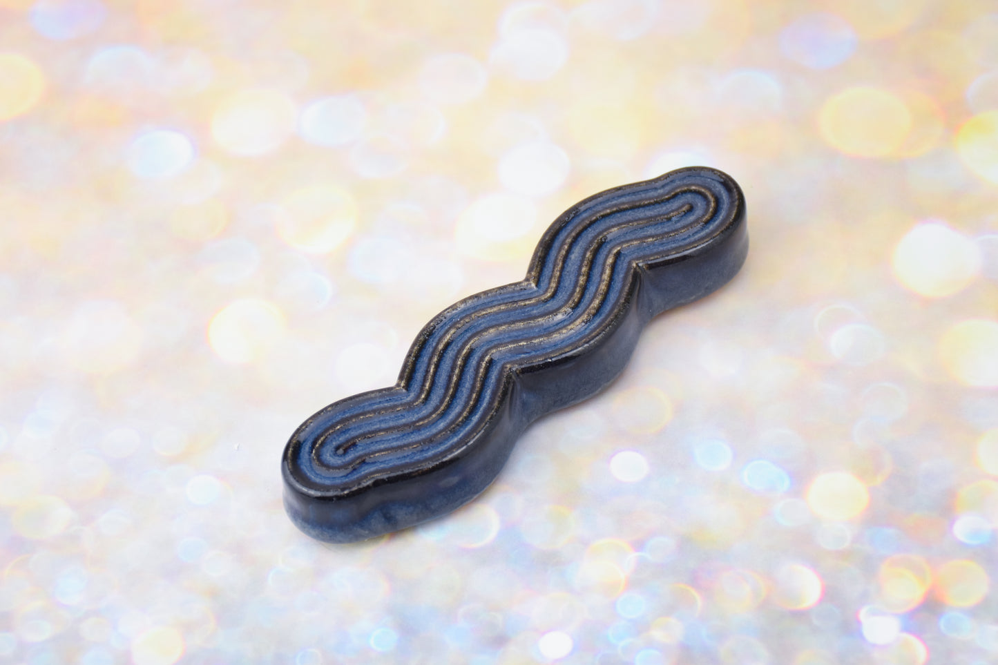 Handmade ceramic mezuzah titled 'Squizuzah Mezuzah - Dark Denim' – modern Judaica by Feldi Studios