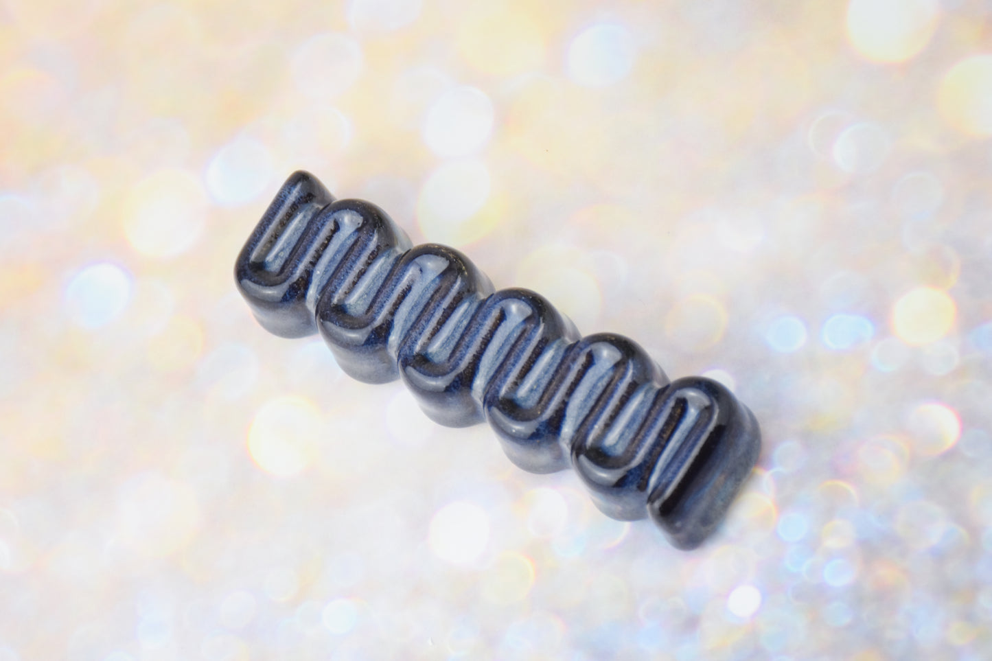 Handmade ceramic mezuzah titled 'Ribbon Mezuzah - Dark Denim' – modern Judaica by Feldi Studios
