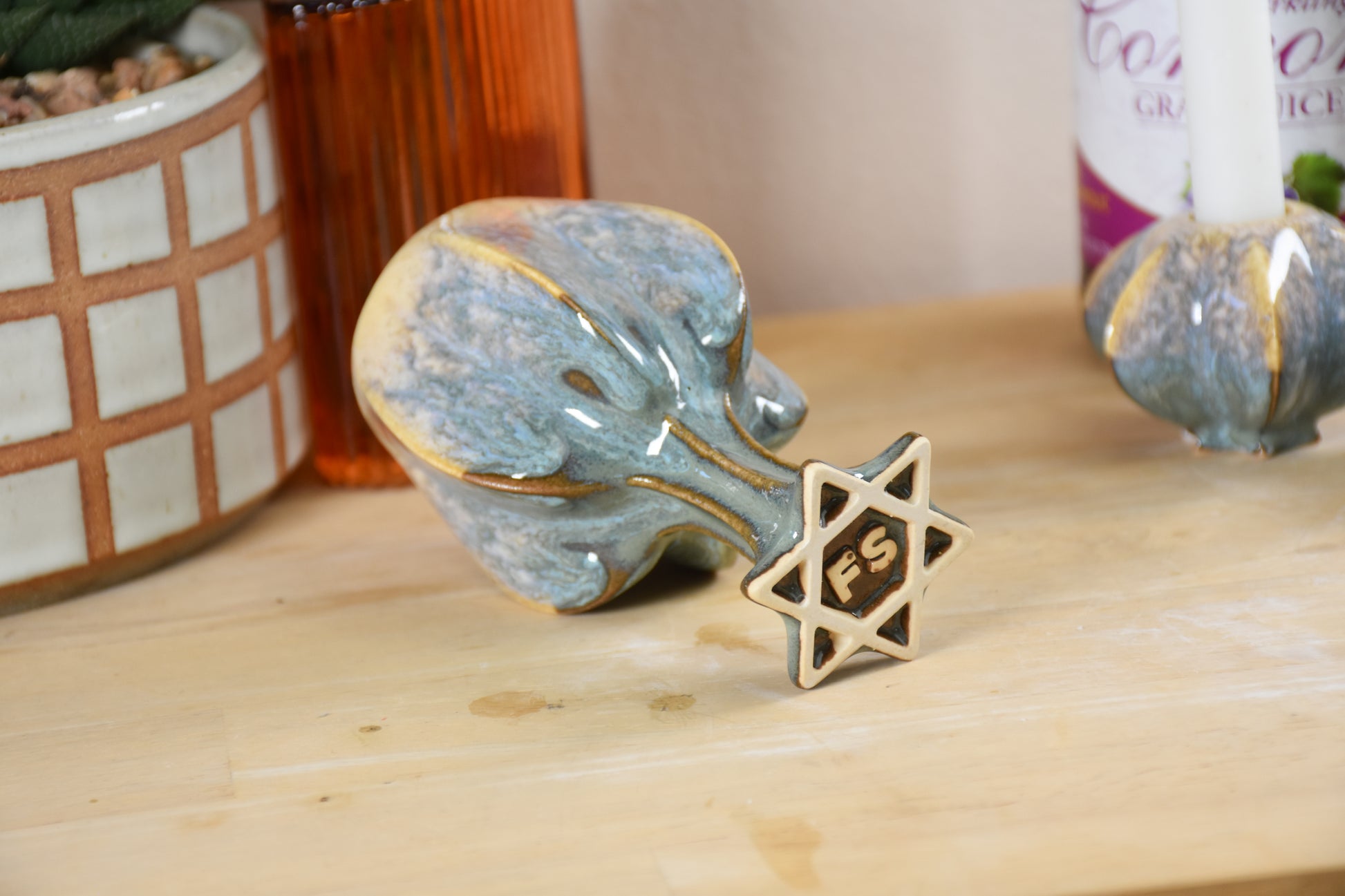 Bottom view of stemmed shabbat kiddush cup showing hidden jewish star design.