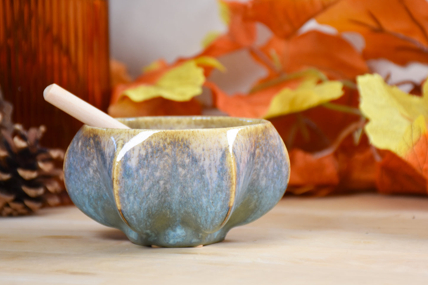 Side view of pomegranate-inspired ceramic honey pot for Jewish New Year