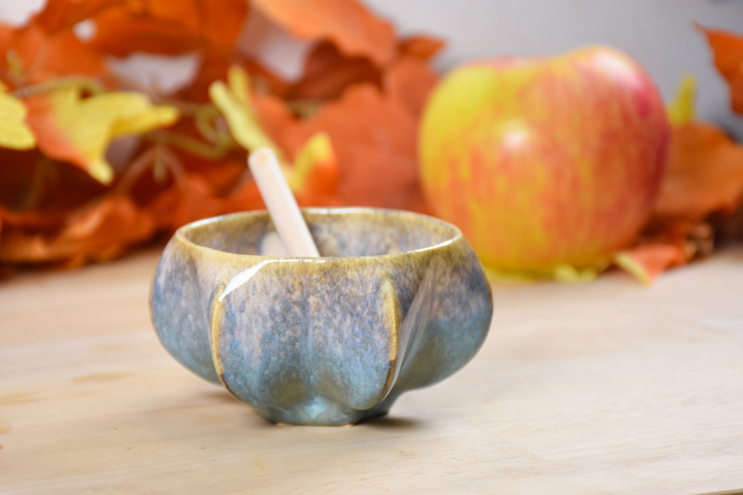 Side view of pomegranate-inspired ceramic honey pot for Jewish New Year