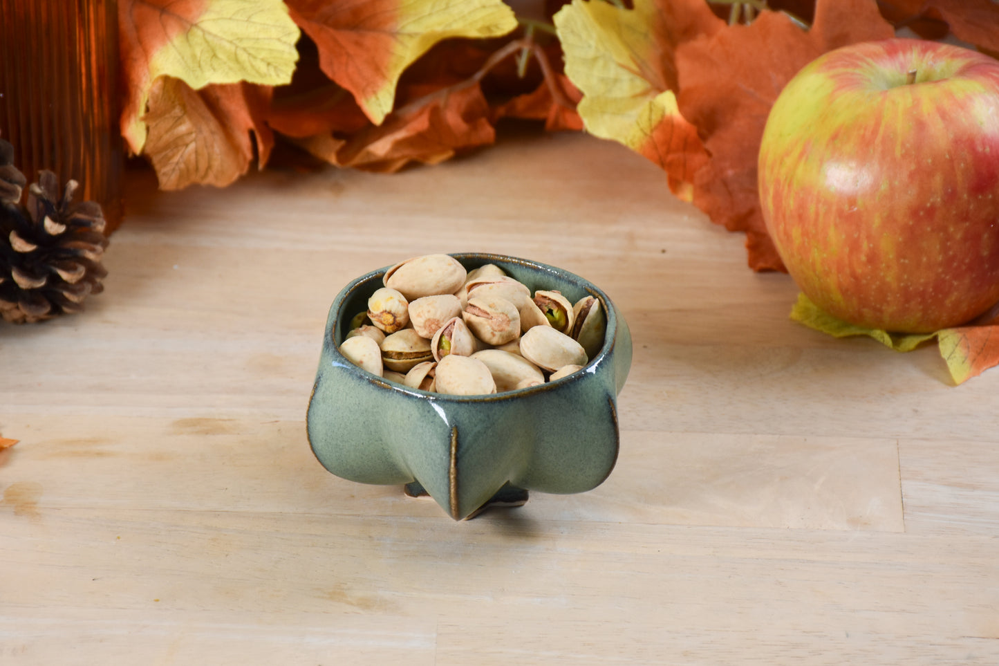 pom honey pot filled with nuts showing product versatility