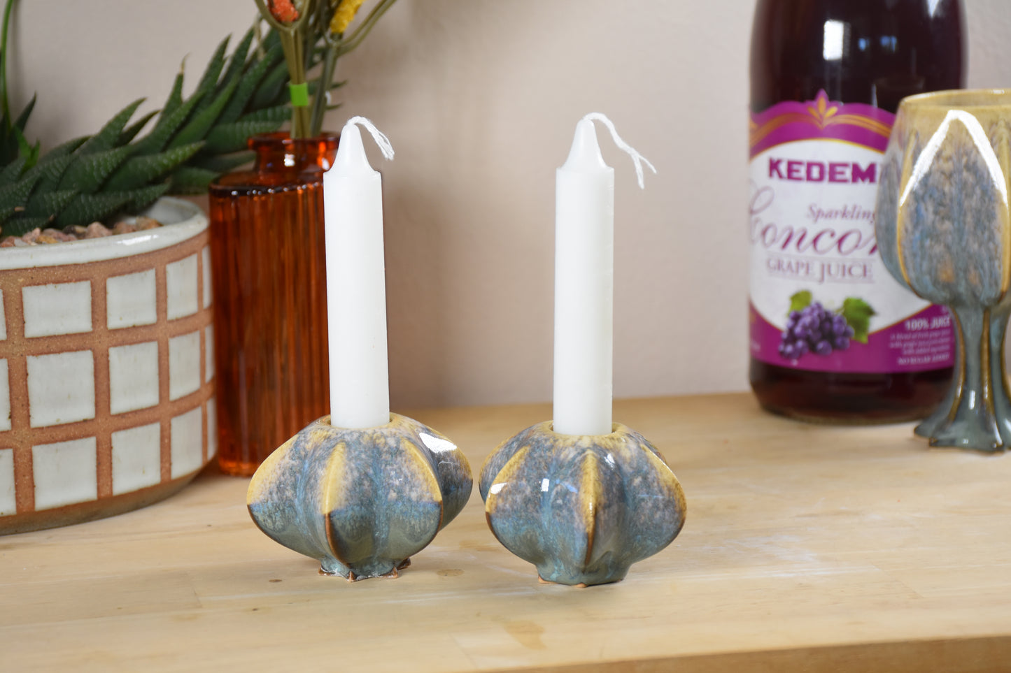 Two jewish star-shaped shabbat candle holders. Handmade ceramic shabbat candle titled 'Shabbat Candle Pair - Gold and Green' – modern Judaica by Feldi Studios