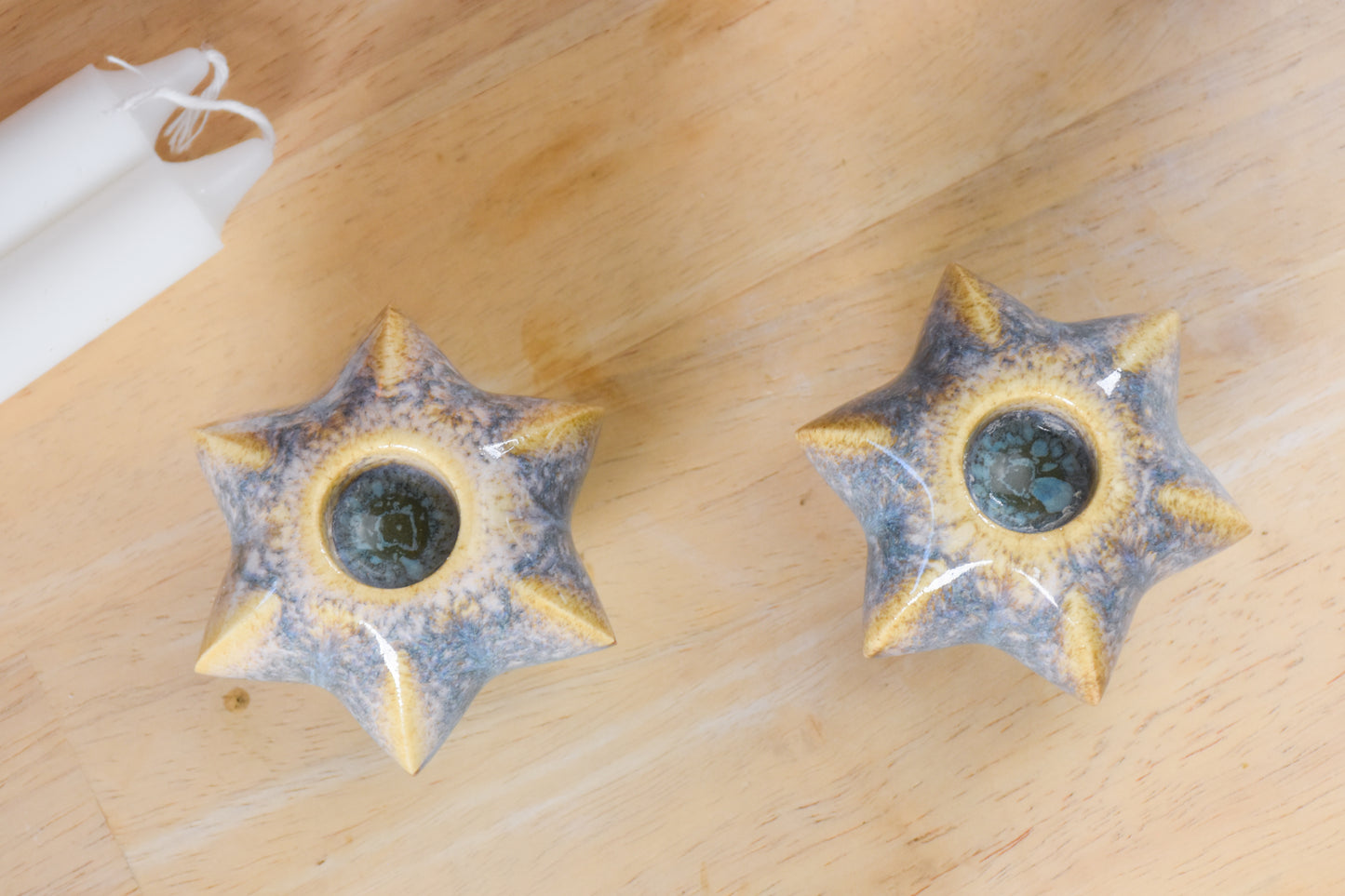 Two jewish star-shaped shabbat candle holders. Handmade ceramic shabbat candle titled 'Shabbat Candle Pair - Gold and Green' – modern Judaica by Feldi Studios