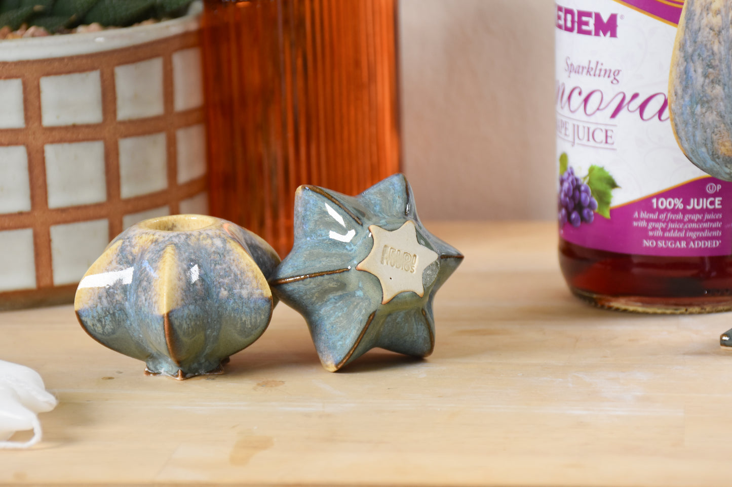 Two jewish star-shaped shabbat candle holders. Handmade ceramic shabbat candle titled 'Shabbat Candle Pair - Gold and Green' – modern Judaica by Feldi Studios