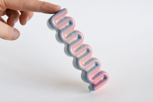 Handmade ceramic mezuzah titled 'Ribbon Mezuzah - Flamingo Fade' â€“ modern Judaica by Feldi Studios