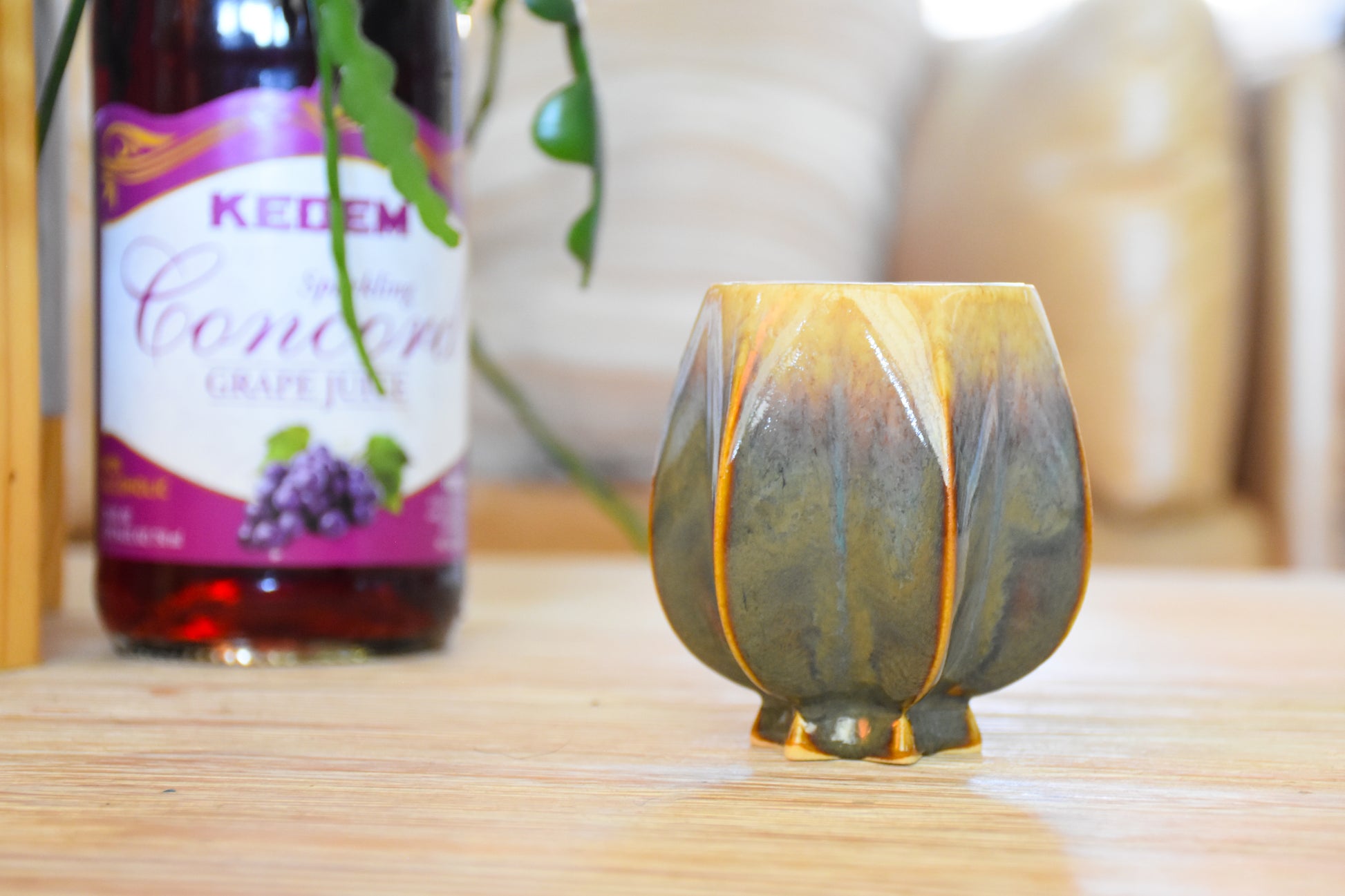 Handmade ceramic kiddush cup titled 'Pom Kiddush Cup - Green + Gold' – modern Judaica by Feldi Studios
