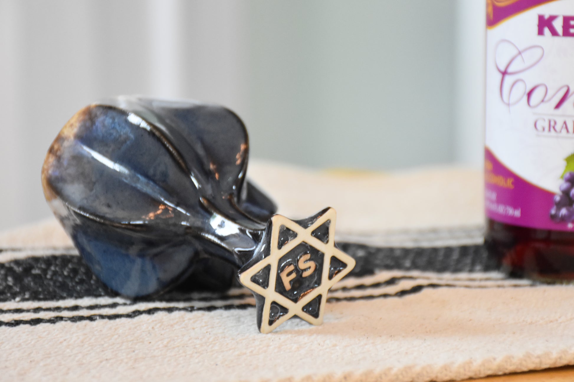 Bottom view of stemmed shabbat kiddush cup showing off secret jewish star design under the foot. 