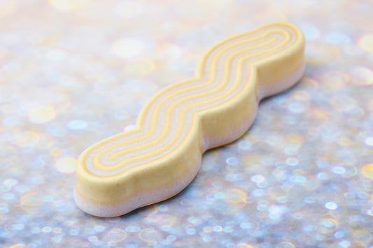Handmade ceramic mezuzah titled 'Squizuzah Mezuzah - Gold' – modern Judaica by Feldi Studios