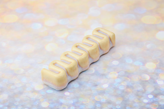Handmade ceramic mezuzah titled 'Ribbon Mezuzah - Gold' – modern Judaica by Feldi Studios