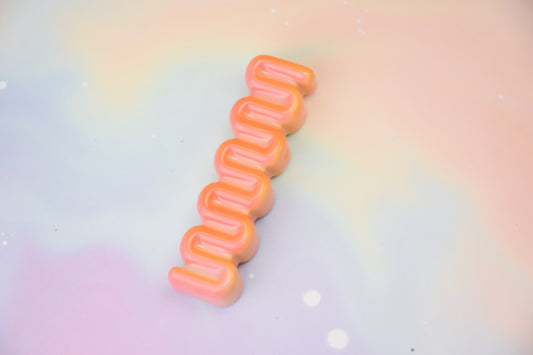 Handmade ceramic mezuzah titled 'Ribbon Mezuzah - Flamingo Fade' – modern Judaica by Feldi Studios