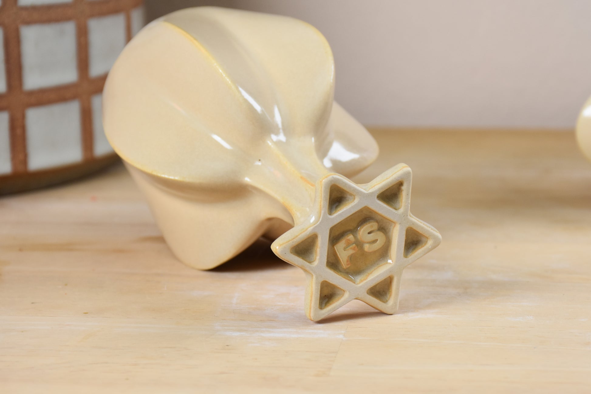 bottom view of stemmed shabbat kiddush cup showing jewish star design in foot. 