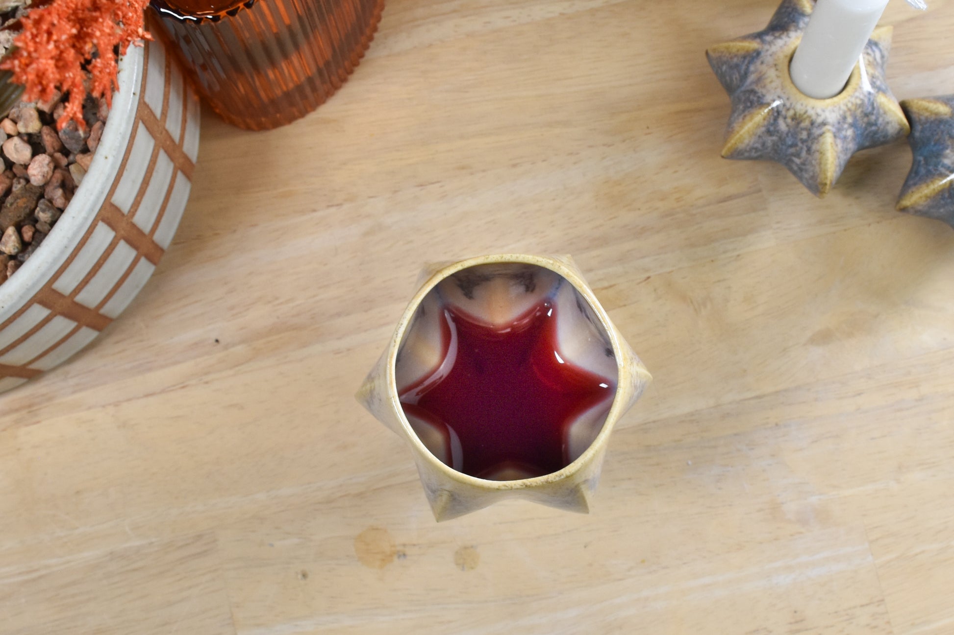 top view of shabbat kiddush cup showing jewish star shape formed with wine. 