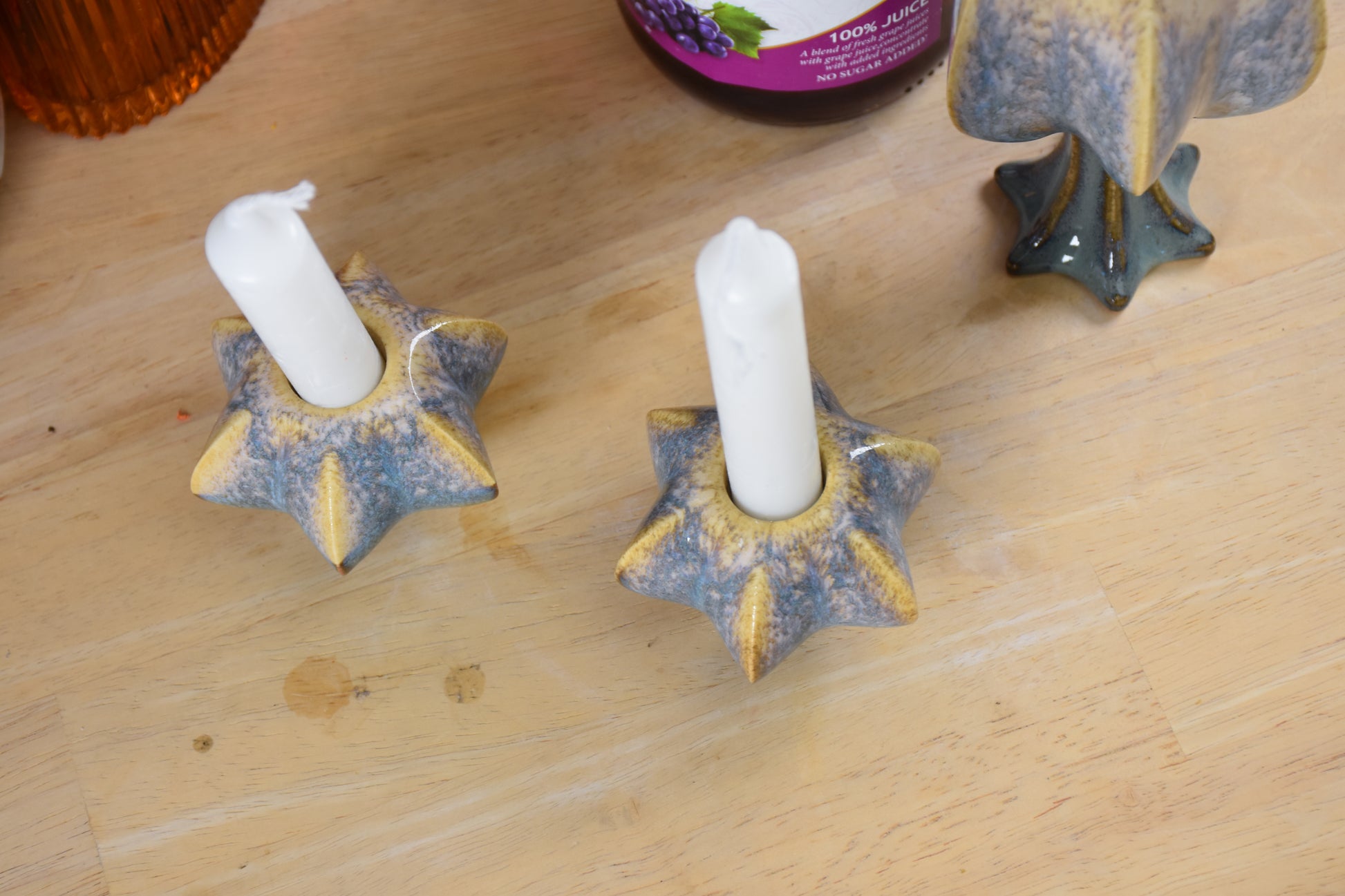 Two jewish star-shaped shabbat candle holders. Handmade ceramic shabbat candle titled 'Shabbat Candle Pair - Gold and Green' – modern Judaica by Feldi Studios