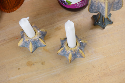 Two jewish star-shaped shabbat candle holders. Handmade ceramic shabbat candle titled 'Shabbat Candle Pair - Gold and Green' – modern Judaica by Feldi Studios